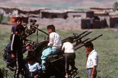 Kurdiske børn i flygtningelejr leger på et efterladt våben, 1991